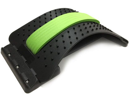 Lumbar Tractor Therapy back stretcher with green foam pad and black spiked surface for massage and spinal support. Ideal for back pain relief.