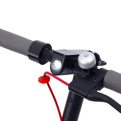 Close-up of Foldable Electric Scooter handlebar showing LED headlight and bell, ideal for safe night rides in urban environments.